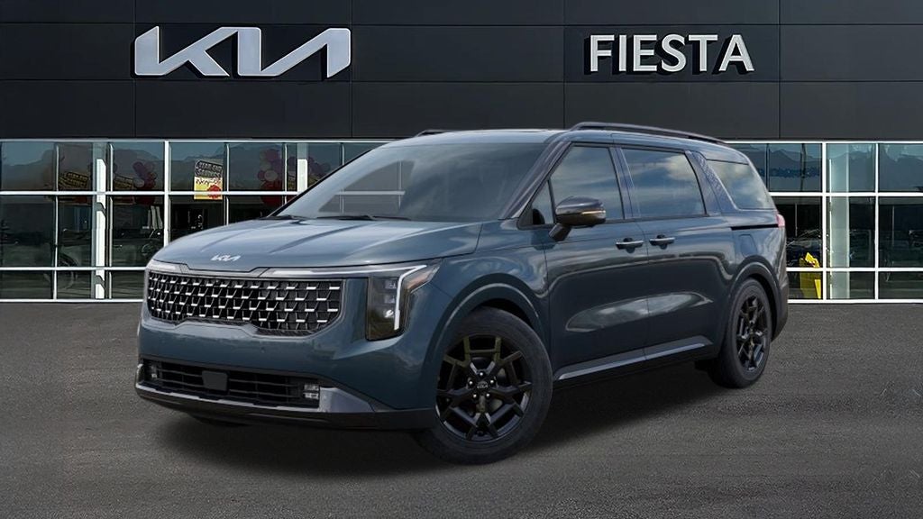 2026 Kia Carnival SX in Astra Blue — front three-quarter view