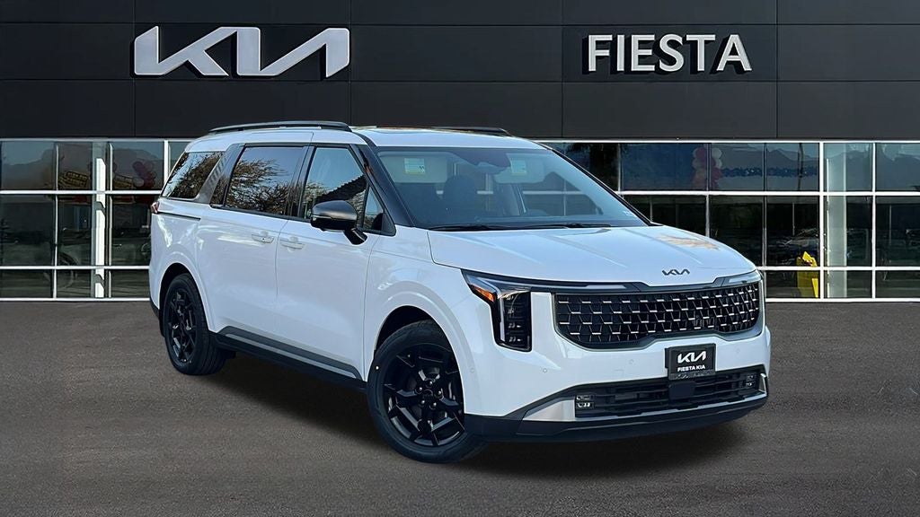 2026 Kia Carnival Hybrid SX Prestige in Snow White Pearl — front three-quarter view